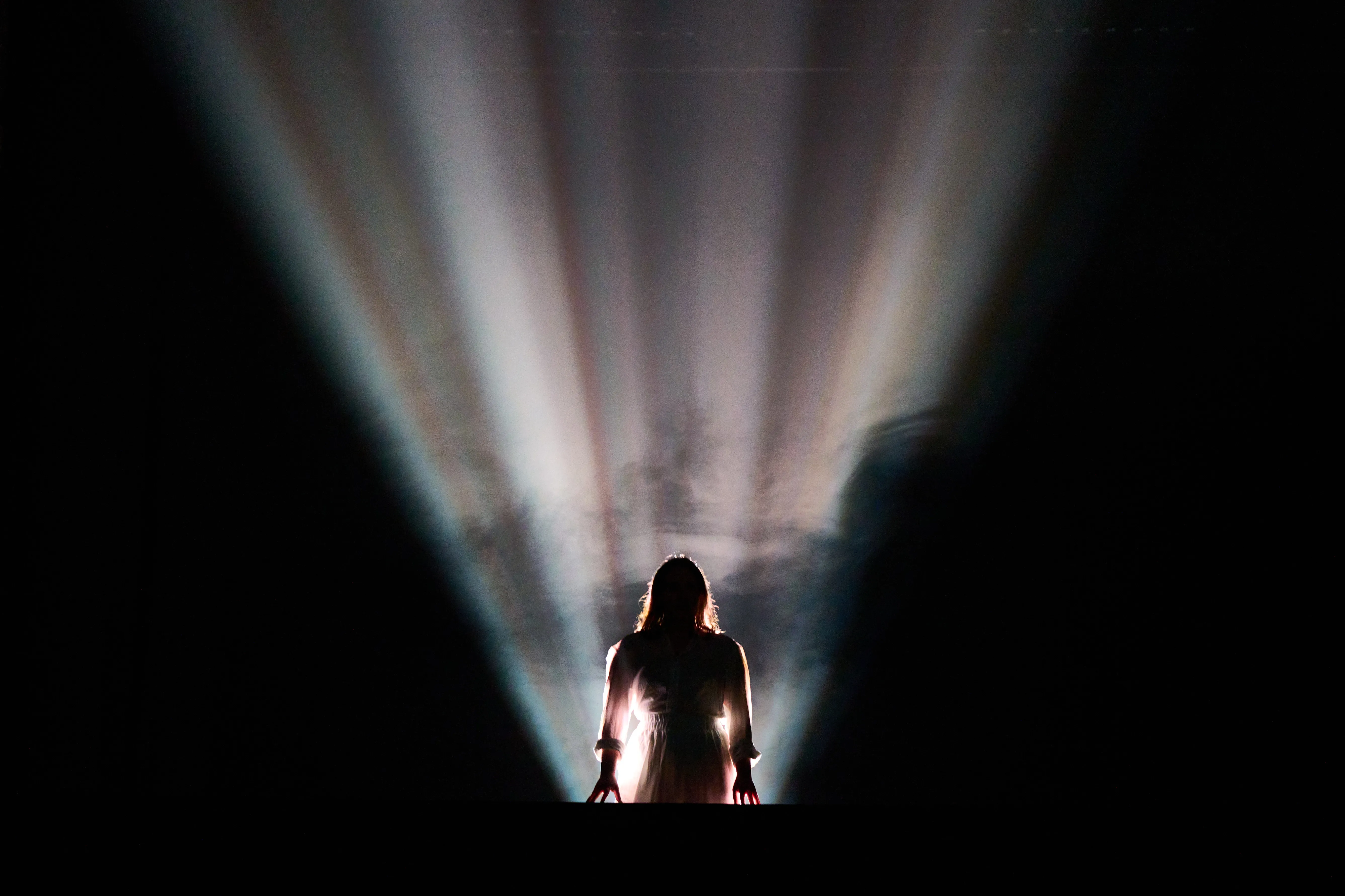 Heather Morrison as Elyria, standing in shafts of light at the Voxel Theater
